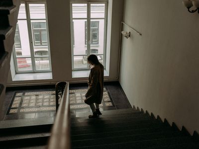 Person doing a tree pose in front of a window.