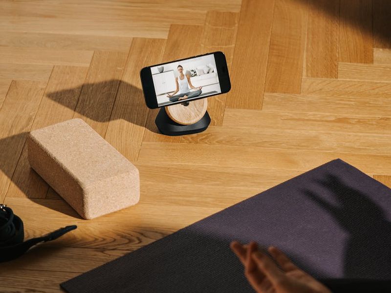 Yoga mat and blocks on a wooden floor.